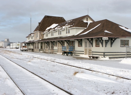 With grain elevators in the distance, railroad tracks lead past the Churchill Station in the Canadian arctic of Churchill, Manitoba, near the Hudson Bay