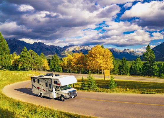 Recreational Vehicle Driving on Autumn Highway In Beautiful Mountains Wilderness in Jasper, AB, Canada