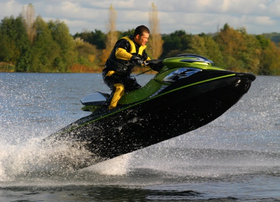 A jet ski and its rider leap clear of the water